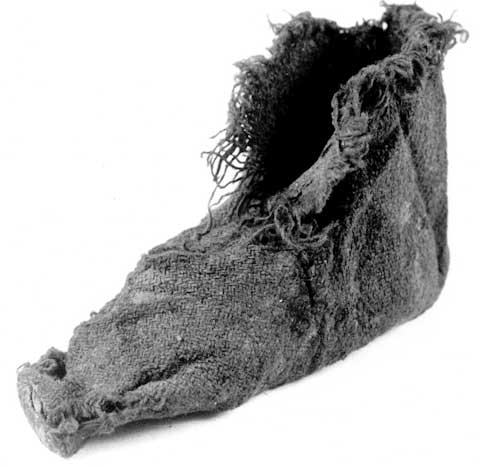 A child's woollen sock, with an upper and a sole tacked together. Footwear has revealed women and children as well as soldiers living at Vindolanda.