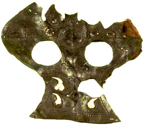 An almost complete horse chamfron (cover worn over the front of the horse's head), retaining some of the brass studs and plaques with which it was originally decorated