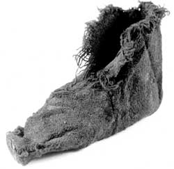 A child's woollen sock, with an upper and a sole tacked together. Footwear has revealed women and children as well as soldiers living at Vindolanda.