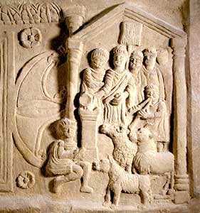 A relief depicting a sacrifice scene on the Bridgeness slab (from the Antonine Wall, Scotland). In the foreground  are the victims, a boar, ram and bull, with a servant and flute player. Behind them the celebrant pours a libation on the altar.