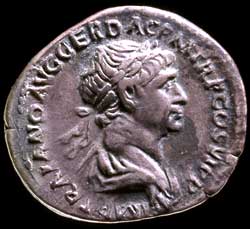 The obverse of a silver coin (denarius) of the emperor Trajan, with the emperor's bust. AD 112-14.